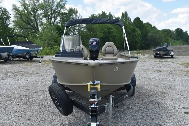 Slide: The Image of 2025 Lund 1875 Alaskan SS boat on trailer, parked outdoors. - 2