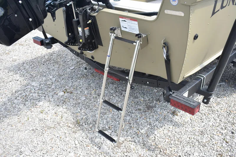 Slide: The Image of 2025 Lund 1875 Alaskan SS boat with a foldable ladder on gravel surface. - 7