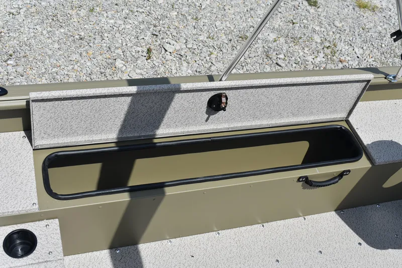 Slide: The Image of 2025 Lund 1875 Alaskan SS boat storage compartment with open lid on gravel background. - 9