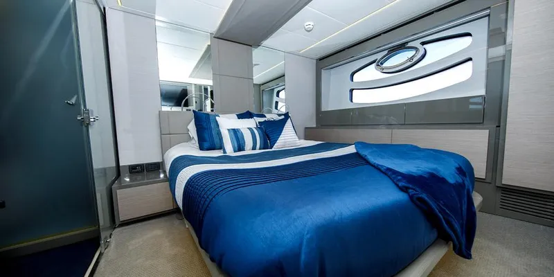 Slide: The Image of Luxurious bedroom interior on 2015 Pershing 62' yacht with blue bedding and modern design. - 10