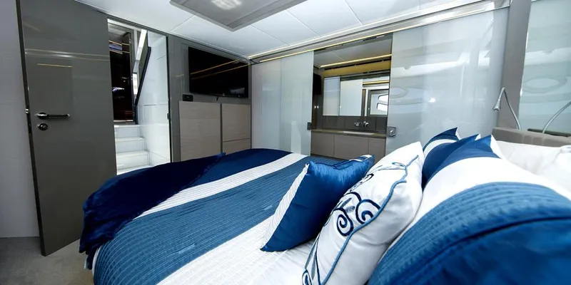 Slide: The Image of Luxurious bedroom interior of 2015 Pershing 62' yacht with blue and white decor. - 9
