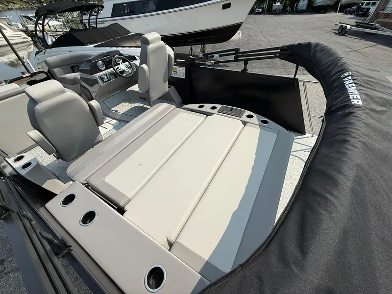 Slide: The Image of 2025 Premier 210 Sunsation RL pontoon boat interior with seating and steering console. - 10