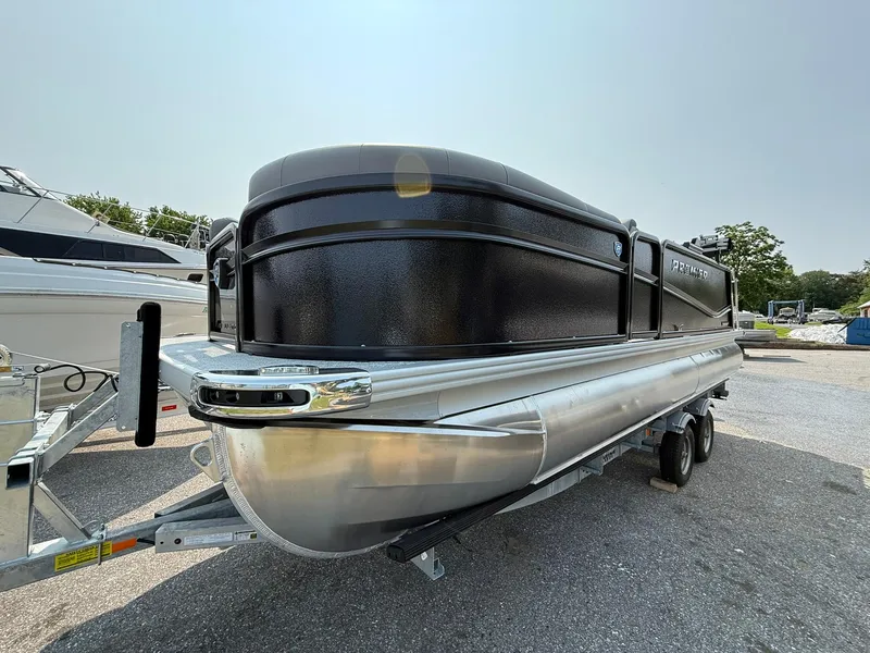 Slide: The Image of 2025 Premier 210 Sunsation RL pontoon boat on trailer, sleek black design. - 14