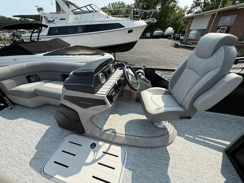 Slide: The Image of 2025 Premier 210 Sunsation RL boat interior with modern helm and comfortable seating. - 3