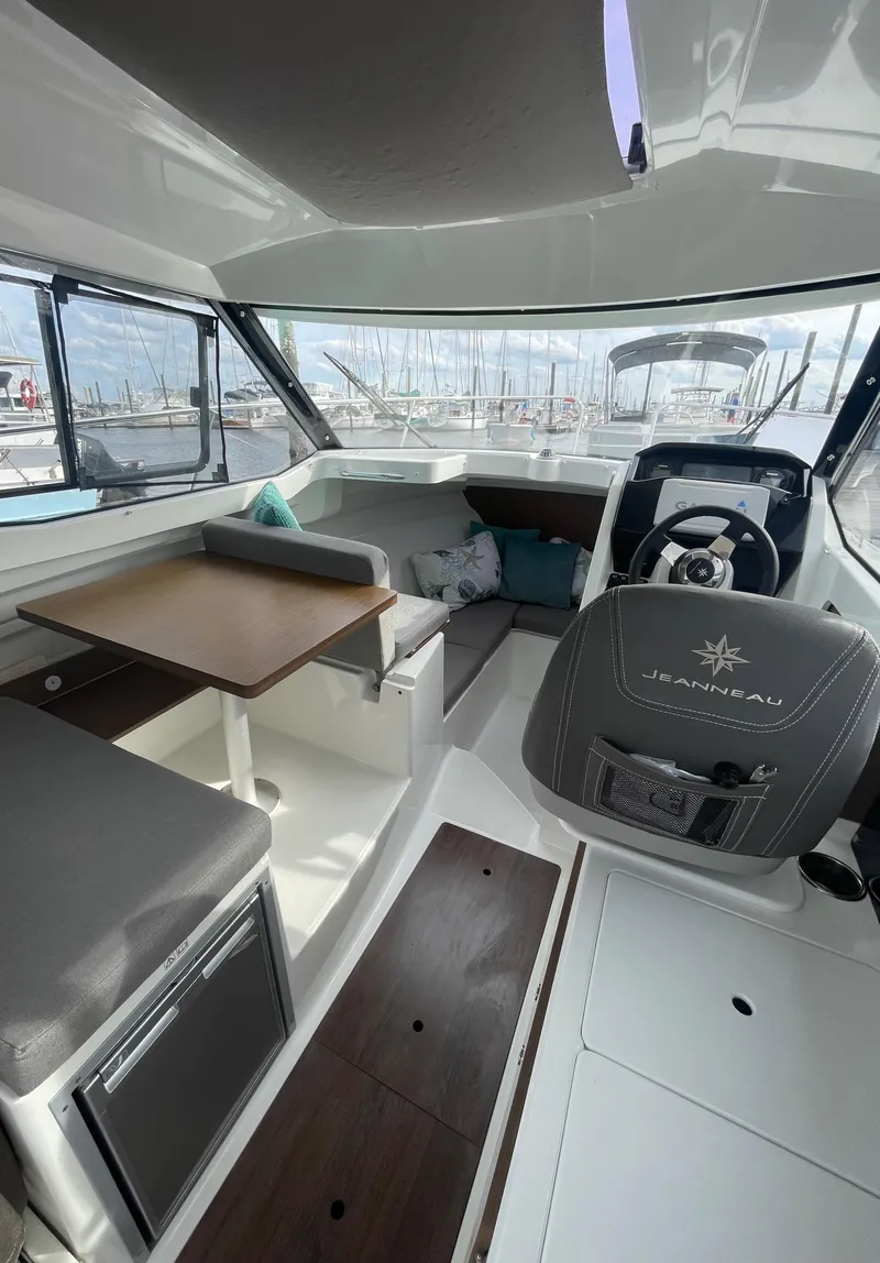 Slide: The Image of Interior of 2019 Jeanneau NC 695 boat with seating and helm. - 12