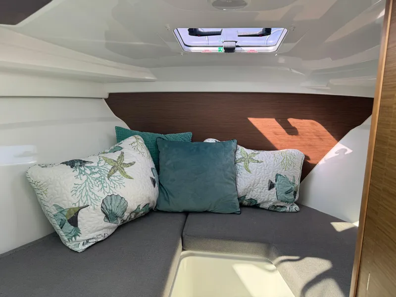 Slide: The Image of Cozy cabin interior of 2019 Jeanneau NC 695 with decorative pillows and skylight. - 15