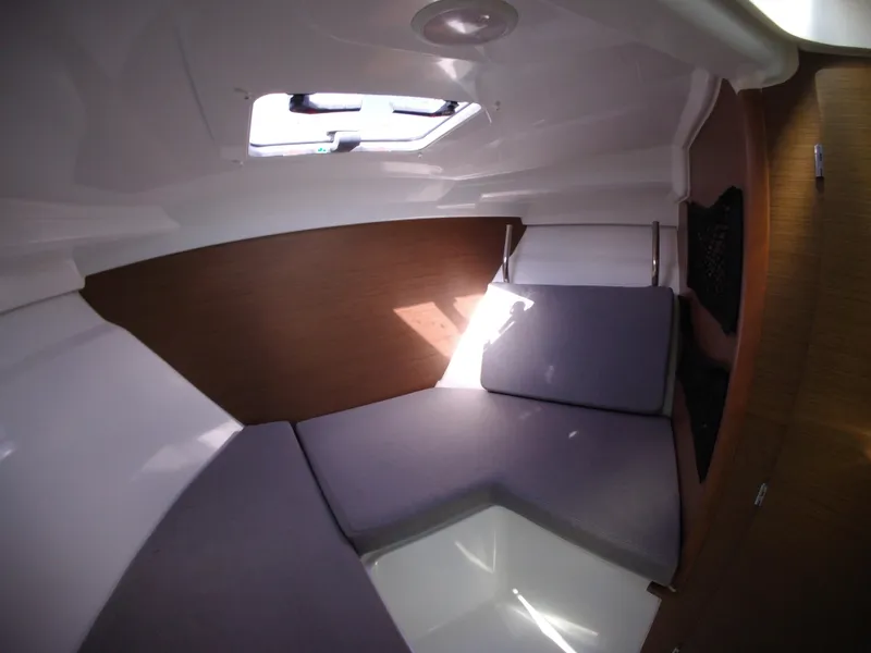 Slide: The Image of Interior cabin of 2019 Jeanneau NC 695 boat with cushions and natural light. - 22