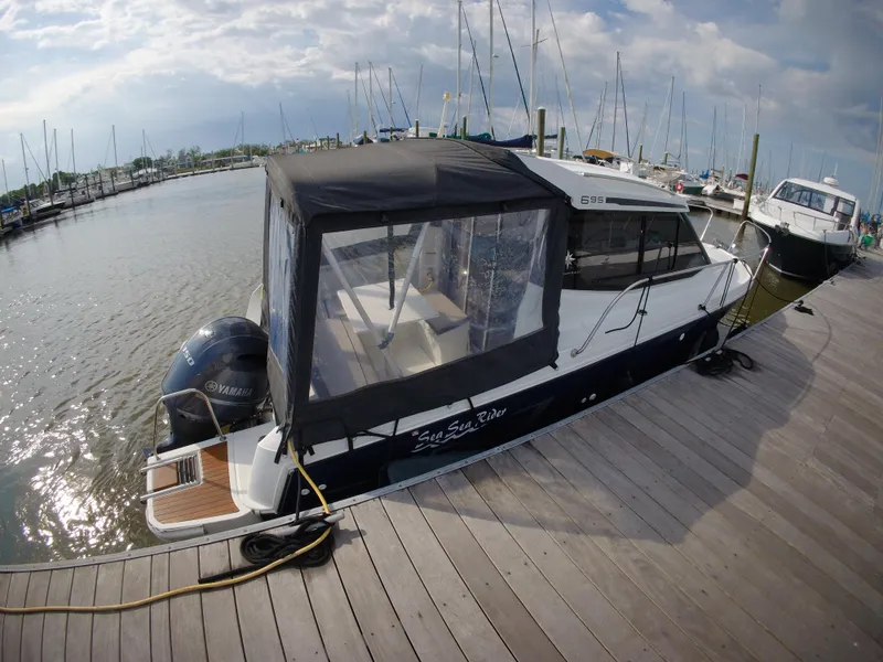 Slide: The Image of 2019 Jeanneau NC 695 boat docked at marina with Yamaha outboard motor. - 3