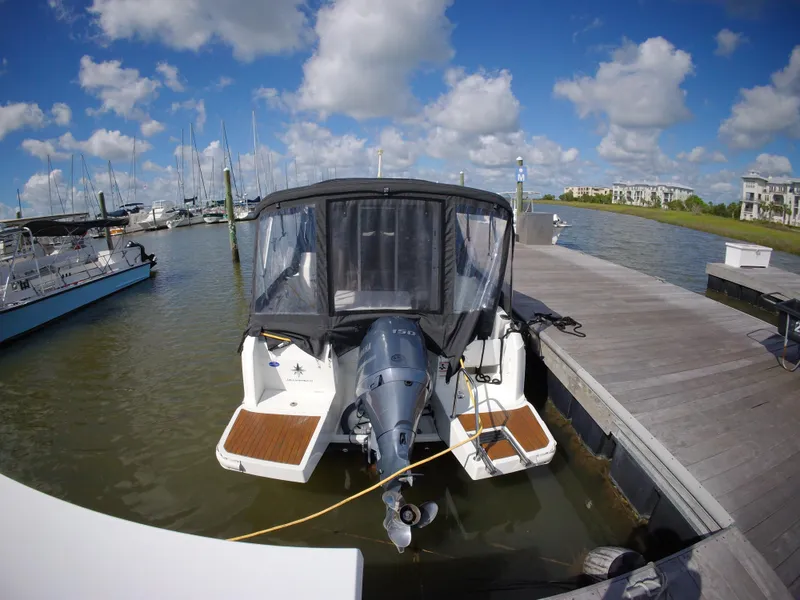 Slide: The Image of 2019 Jeanneau NC 695 boat docked at marina under blue sky. - 4