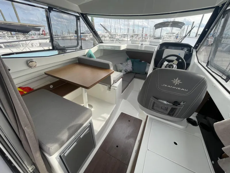 Slide: The Image of Interior of 2019 Jeanneau NC 695 boat with seating, table, and helm. - 8