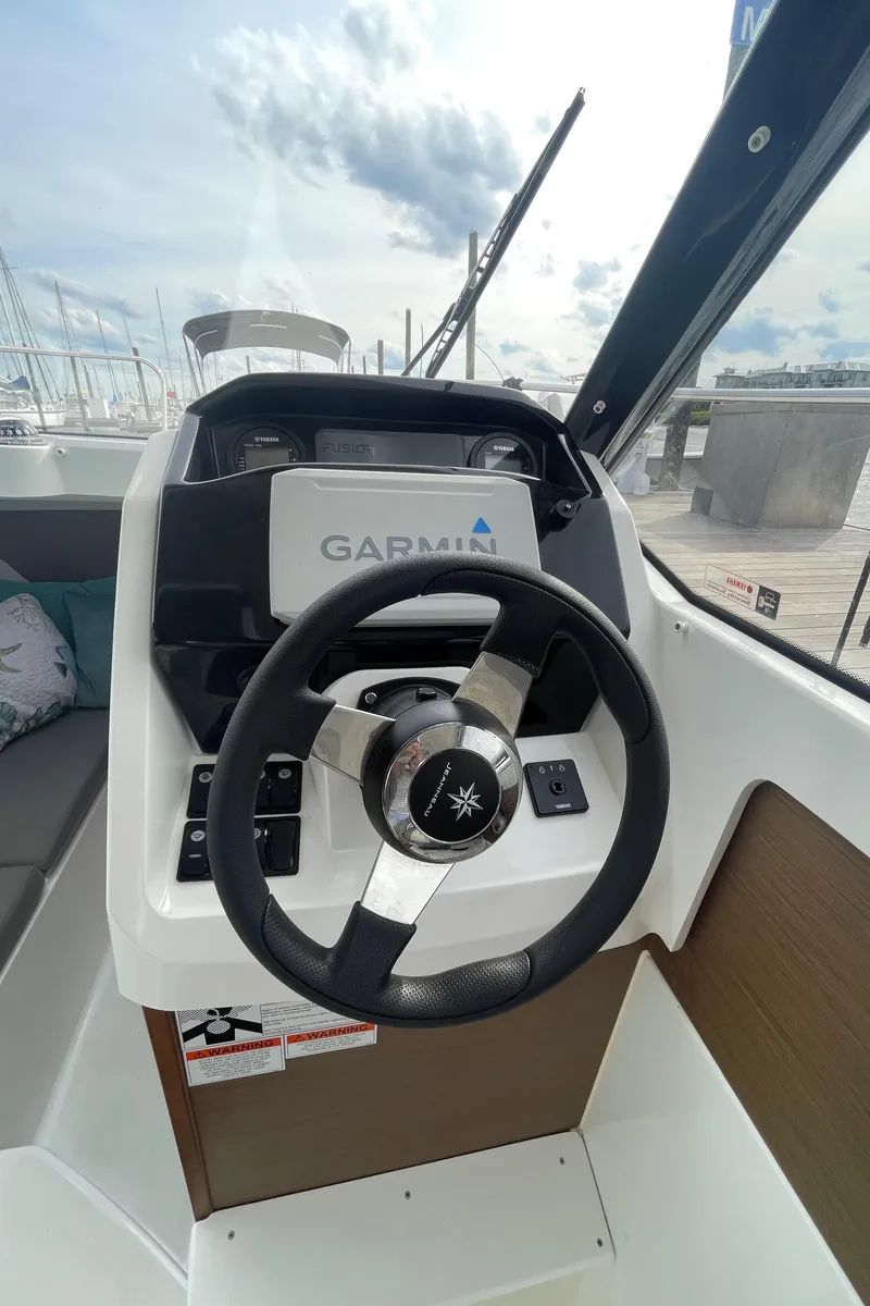 Slide: The Image of 2019 Jeanneau NC 695 helm with Garmin navigation system, dockside view. - 9