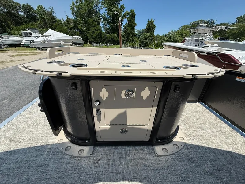 Slide: The Image of 2025 Premier 230 Sunsation Angler 2pt boat deck with storage compartment and cup holders. - 11
