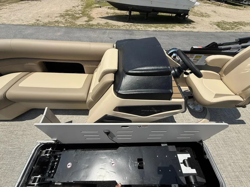 Slide: The Image of 2025 Premier 230 Sunsation Angler 2pt boat interior with beige seating and control panel. - 14