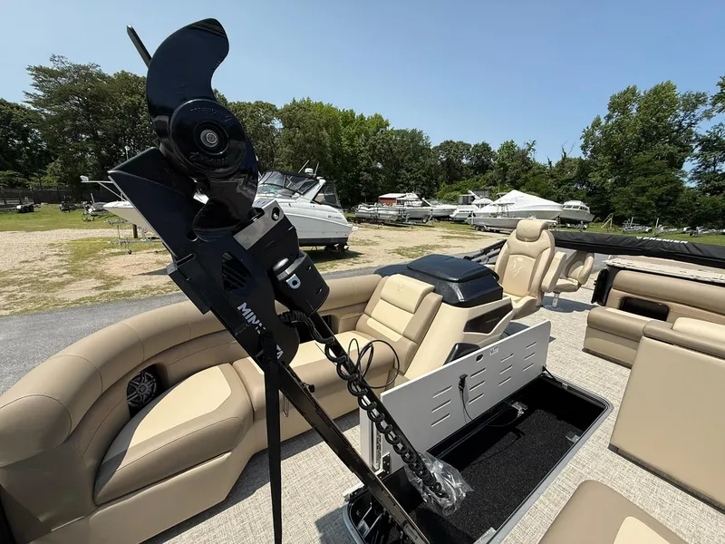 Slide: The Image of 2025 Premier 230 Sunsation Angler 2pt boat interior with seating and equipment, docked outdoors. - 19