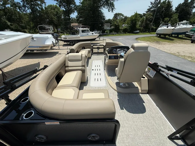 Slide: The Image of 2025 Premier 230 Sunsation Angler 2pt pontoon boat with beige seating and modern dashboard. - 6