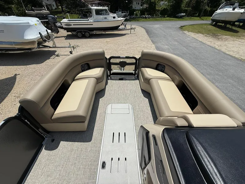 Slide: The Image of 2025 Premier 230 Sunsation Angler 2pt boat interior with beige seating and spacious layout. - 9