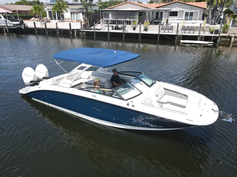 Slide: The Image of 2021 Sea Ray SDX 290 Outboard boat cruising on a calm waterway. - 2