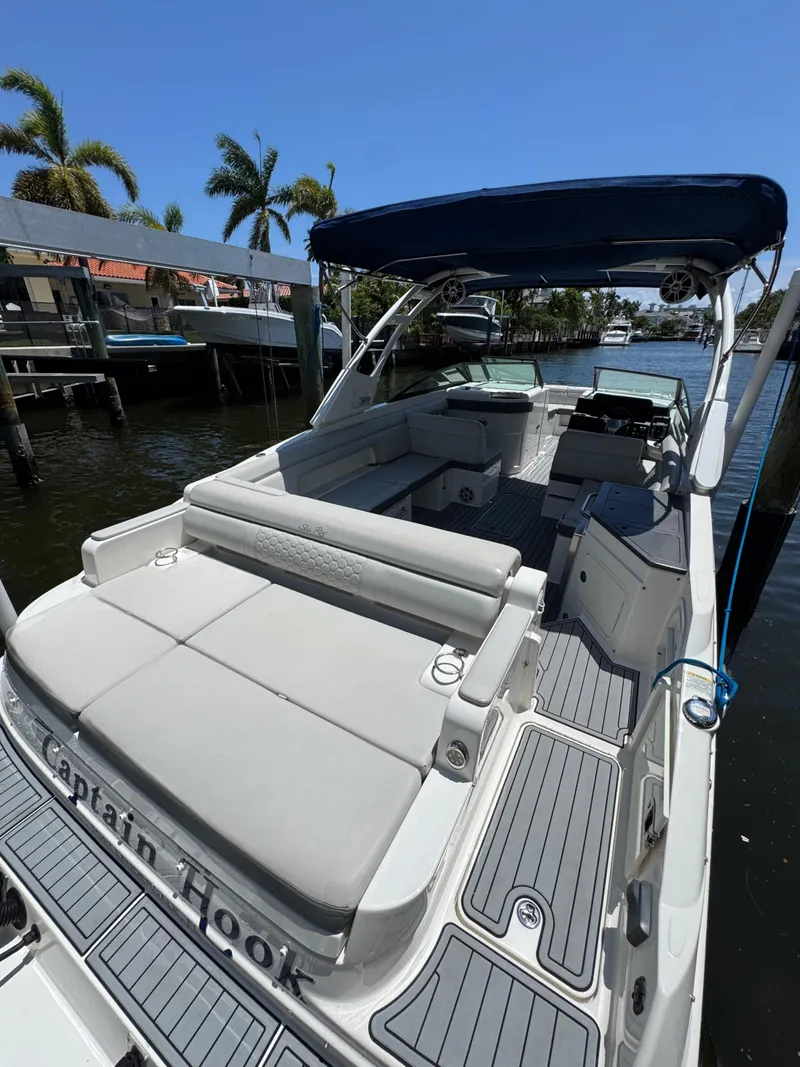 Slide: The Image of 2021 Sea Ray SDX 290 Outboard boat docked, featuring spacious seating and canopy. - 20