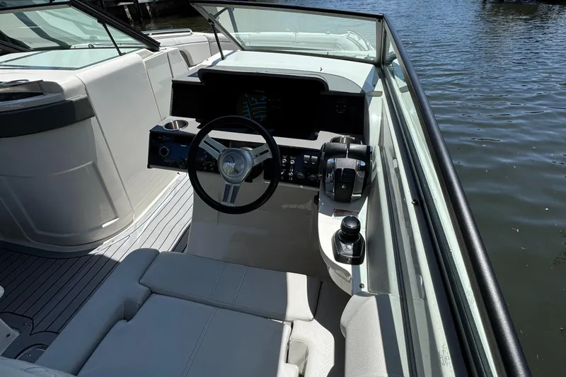 Slide: The Image of 2021 Sea Ray SDX 290 Outboard boat interior with steering wheel and controls. - 29