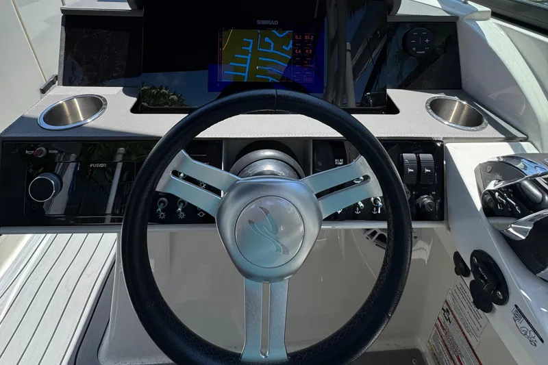 Slide: The Image of 2021 Sea Ray SDX 290 Outboard dashboard with steering wheel and controls. - 30