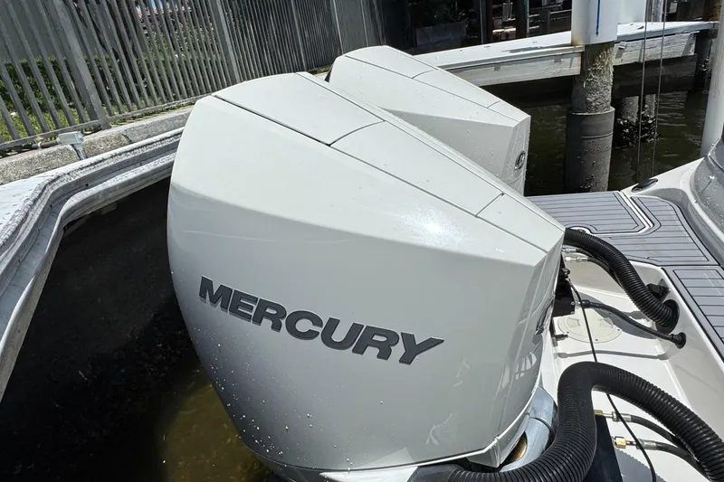 Slide: The Image of Twin Mercury outboard engines on a 2021 Sea Ray SDX 290 boat docked by a pier. - 33