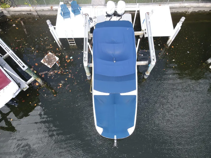 Slide: The Image of Aerial view of a 2021 Sea Ray SDX 290 Outboard docked with blue covers. - 36
