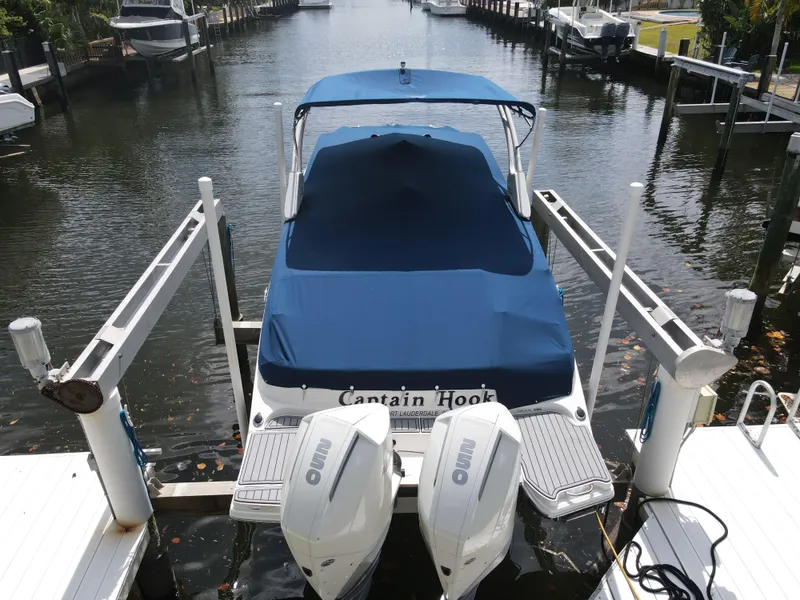 Slide: The Image of 2021 Sea Ray SDX 290 Outboard boat docked with blue cover and twin engines. - 37