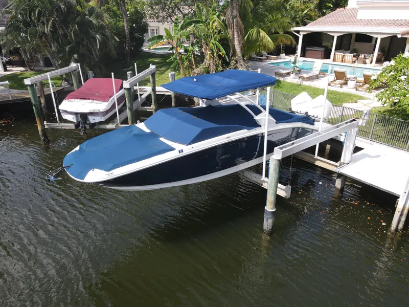 Slide: The Image of 2021 Sea Ray SDX 290 Outboard boat docked at a waterfront property. - 39