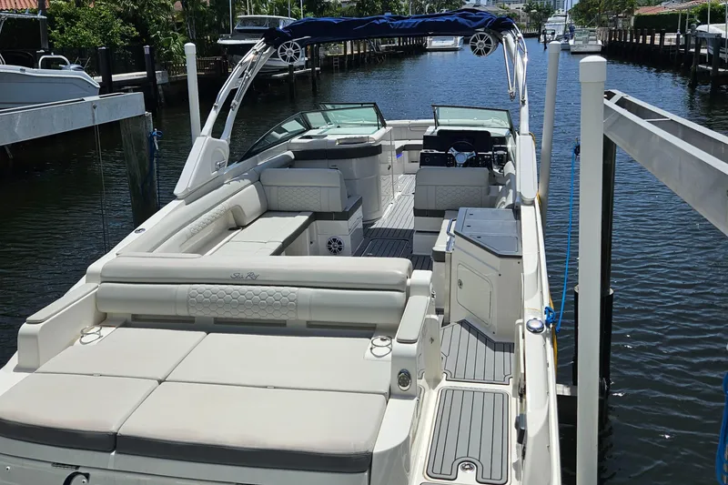 Slide: The Image of 2021 Sea Ray SDX 290 Outboard boat with spacious seating and sleek design docked by a canal. - 42