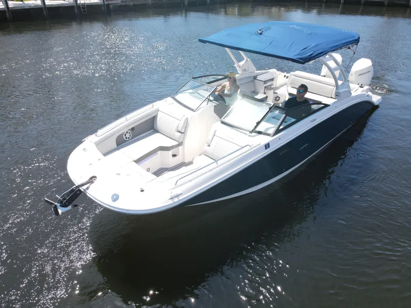 Slide: The Image of 2021 Sea Ray SDX 290 Outboard boat with blue canopy cruising on water. - 5