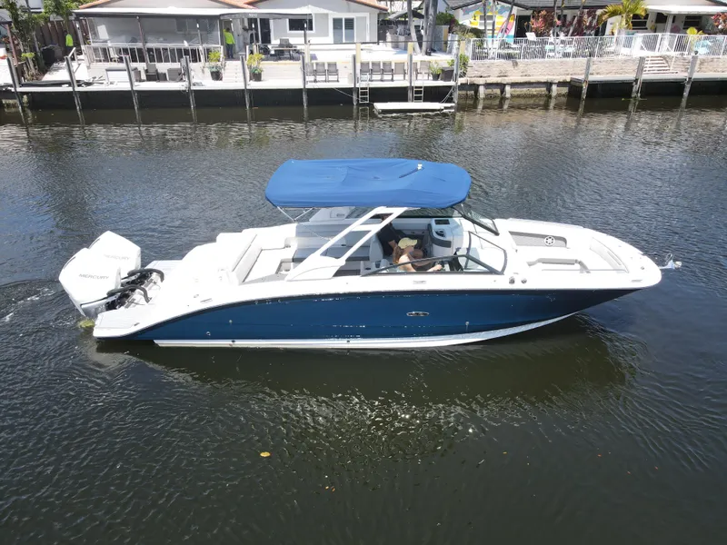 Slide: The Image of 2021 Sea Ray SDX 290 Outboard boat cruising on a calm waterway. - 7