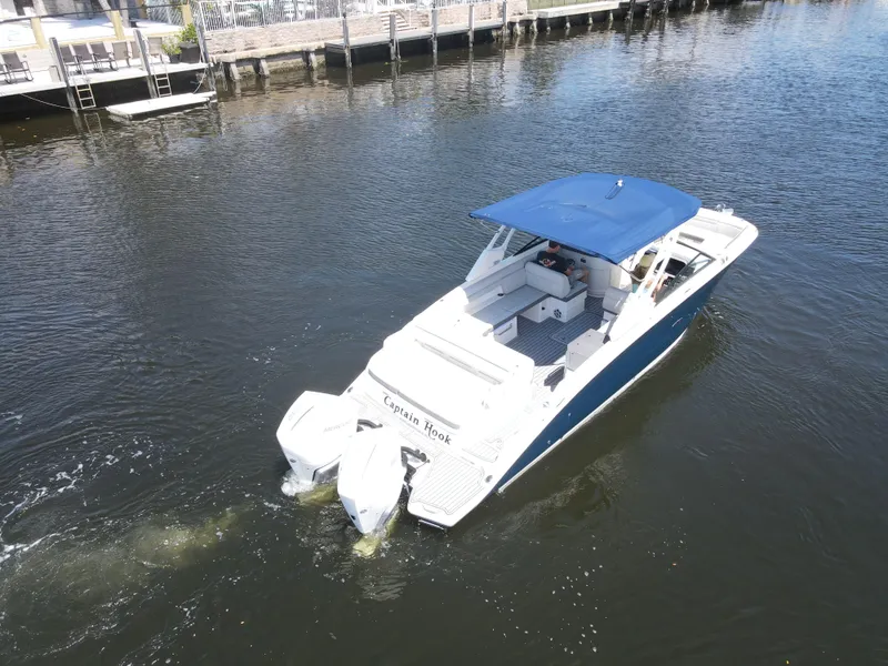 Slide: The Image of 2021 Sea Ray SDX 290 Outboard boat cruising on a calm waterway. - 9