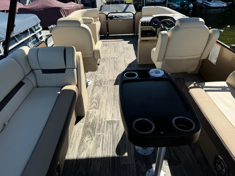 Slide: The Image of 2023 Godfrey SWEETWATER 2186 SB pontoon boat interior with beige seating and a central table. - 14