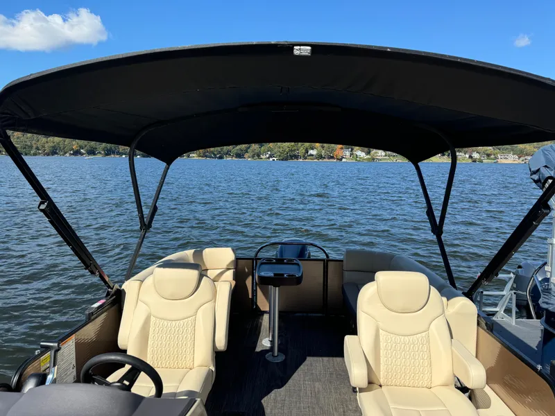 Slide: The Image of 2023 Godfrey SWEETWATER 2186 SB pontoon boat on a lake under a clear blue sky. - 7