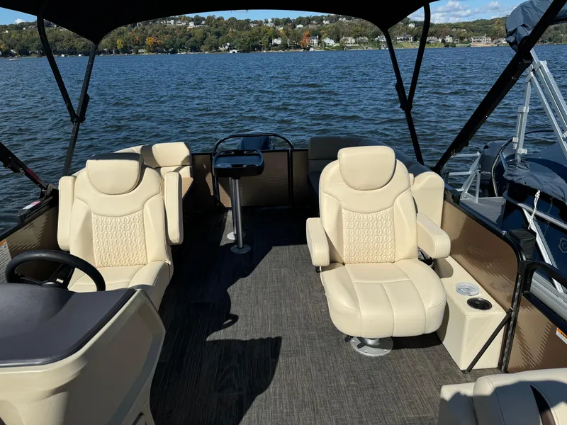 Slide: The Image of 2023 Godfrey SWEETWATER 2186 SB pontoon boat interior with beige seating on a lake. - 8