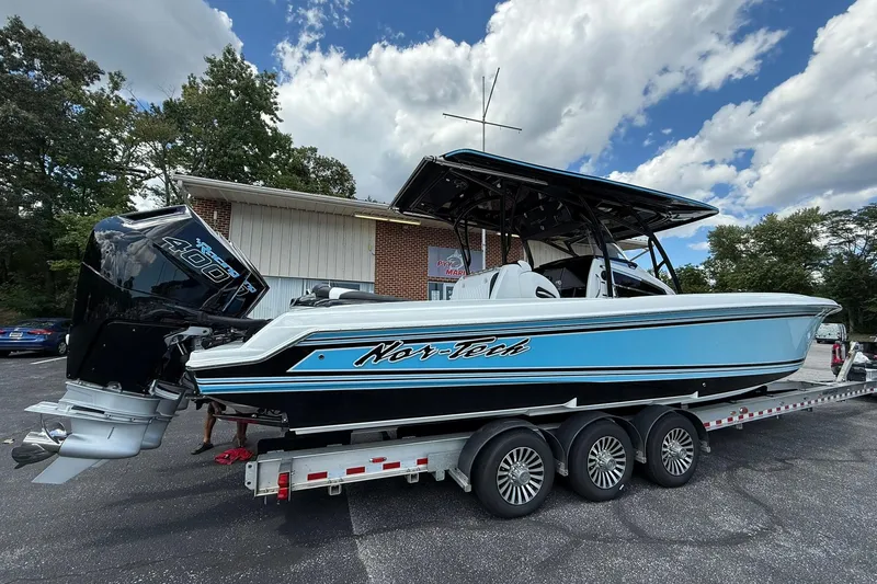 Slide: The Image of 2026 Nor-Tech 340 Sport boat on trailer, featuring powerful engines and sleek design. - 2