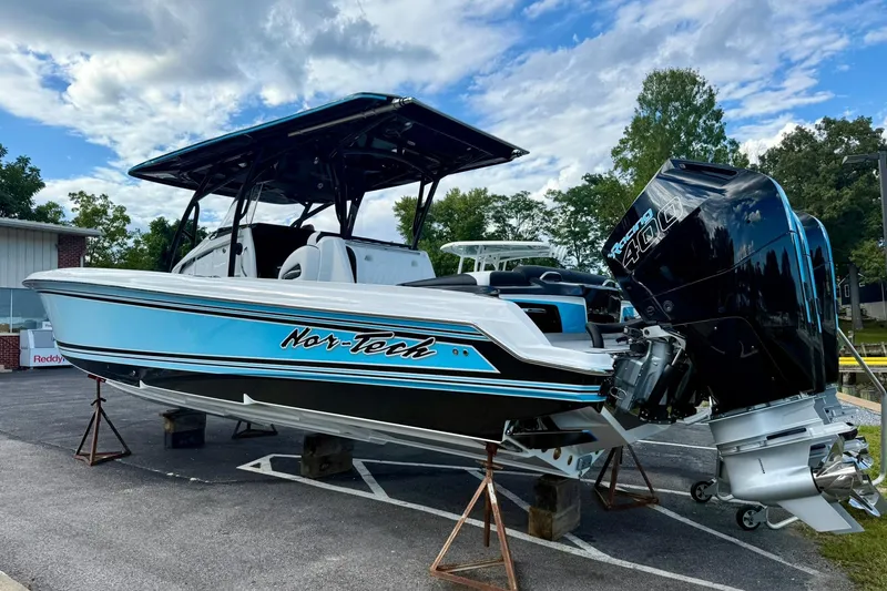 Slide: The Image of 2026 Nor-Tech 340 Sport boat with powerful outboard engines, displayed outdoors. - 3