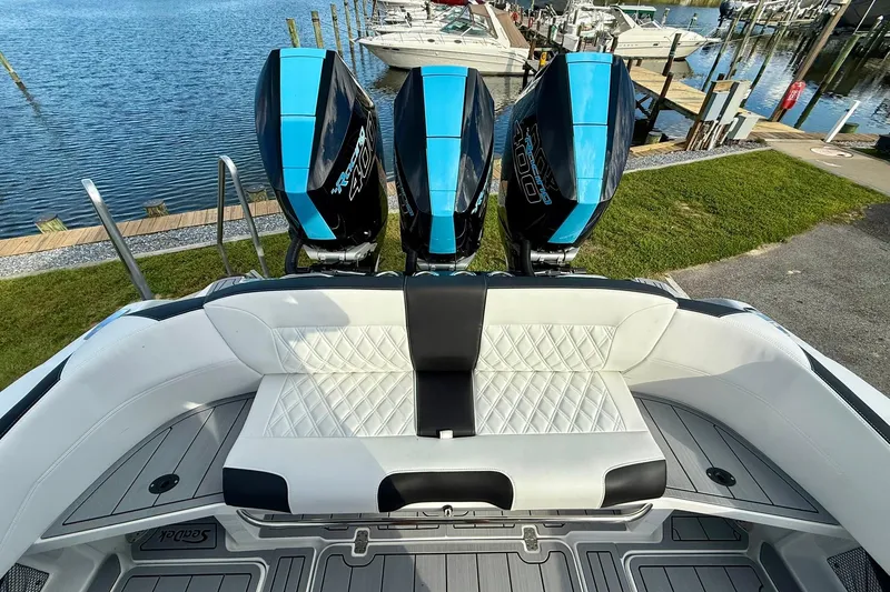 Slide: The Image of 2026 Nor-Tech 340 Sport boat with triple engines, luxurious seating, docked by the water. - 9