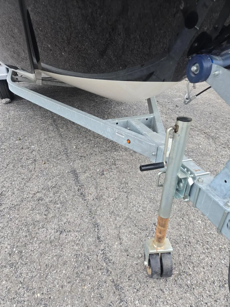 Slide: The Image of 2022 Bayliner Trophy T18Bay boat trailer on asphalt surface. - 13