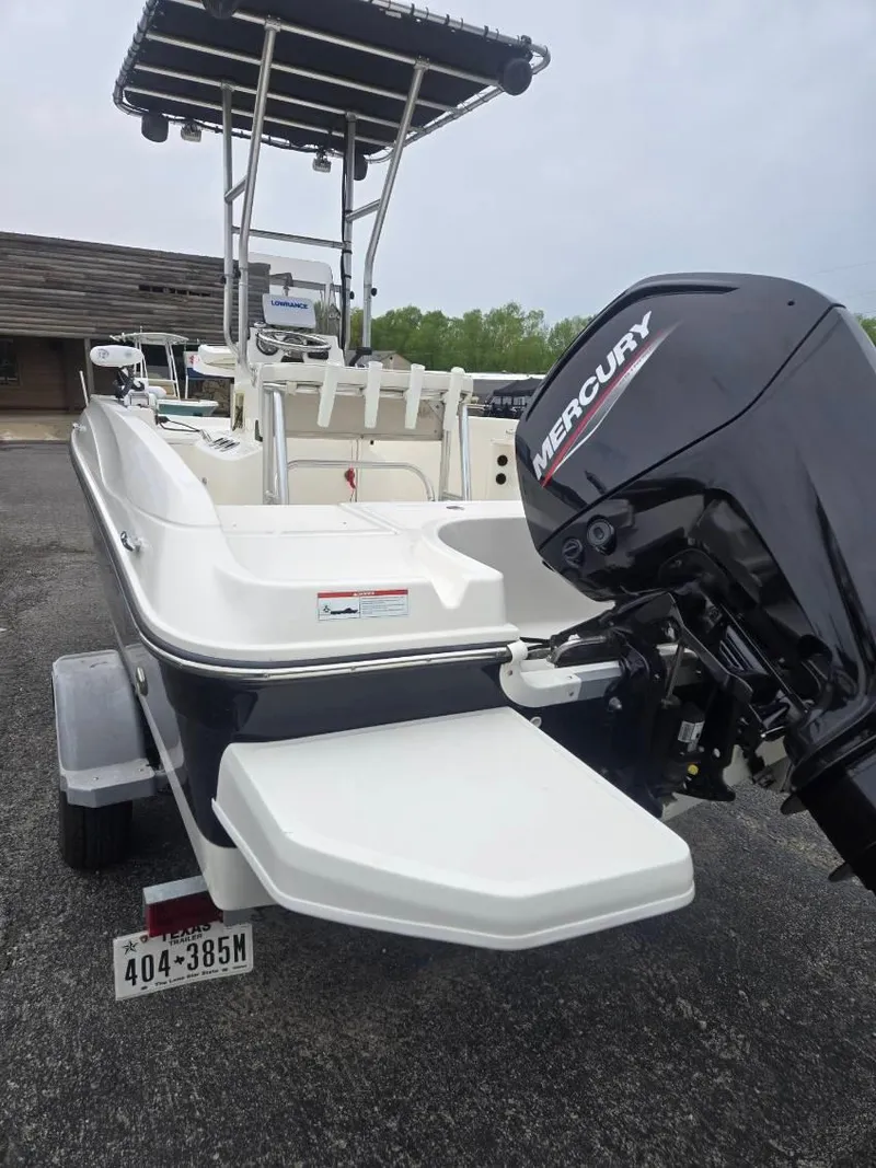 Slide: The Image of 2022 Bayliner Trophy T18Bay boat with Mercury engine, parked on a trailer. - 3