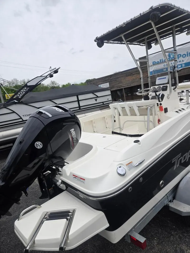 Slide: The Image of 2022 Bayliner Trophy T18Bay boat with Mercury outboard motor, docked at a marina. - 4