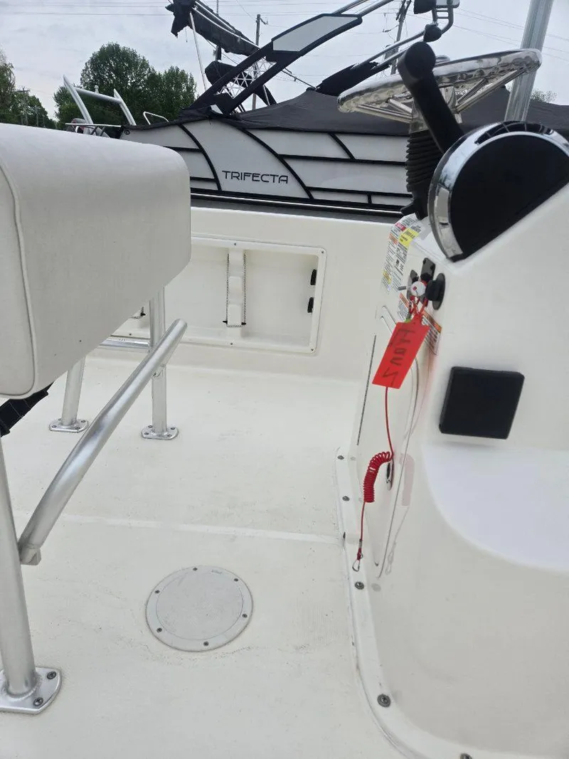 Slide: The Image of 2022 Bayliner Trophy T18Bay boat interior with control panel and seating. - 8