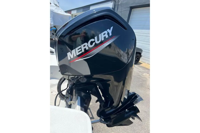 Slide: The Image of 2021 Tahoe T16 boat interior with steering wheel and seating, docked outdoors. - 7