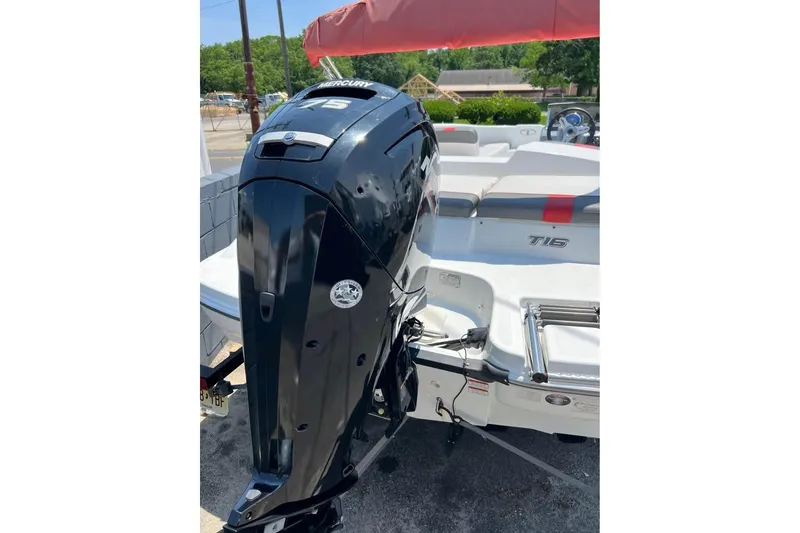 Slide: The Image of 2021 Tahoe T16 boat with Mercury outboard motor, parked outdoors. - 9