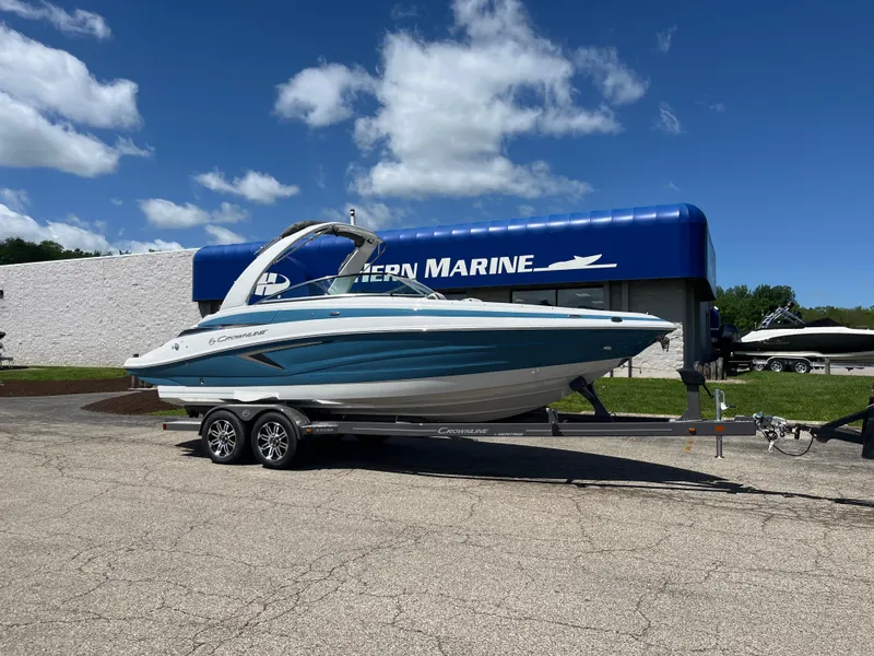 The Image of 2024 Crownline 270 SS boat on trailer outside marine dealership. - 0