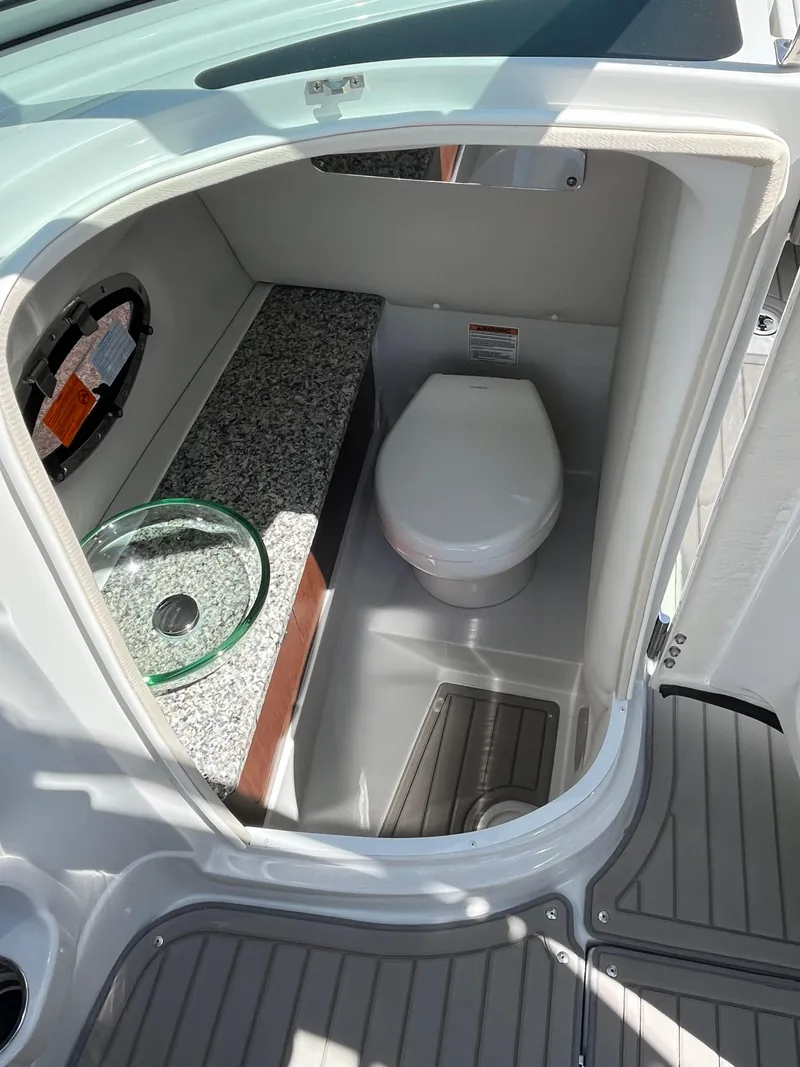 Slide: The Image of 2024 Crownline 270 SS boat interior with modern bathroom amenities. - 13
