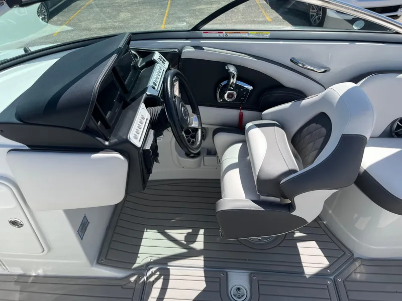 Slide: The Image of 2024 Crownline 270 SS boat interior with modern helm and comfortable seating. - 14