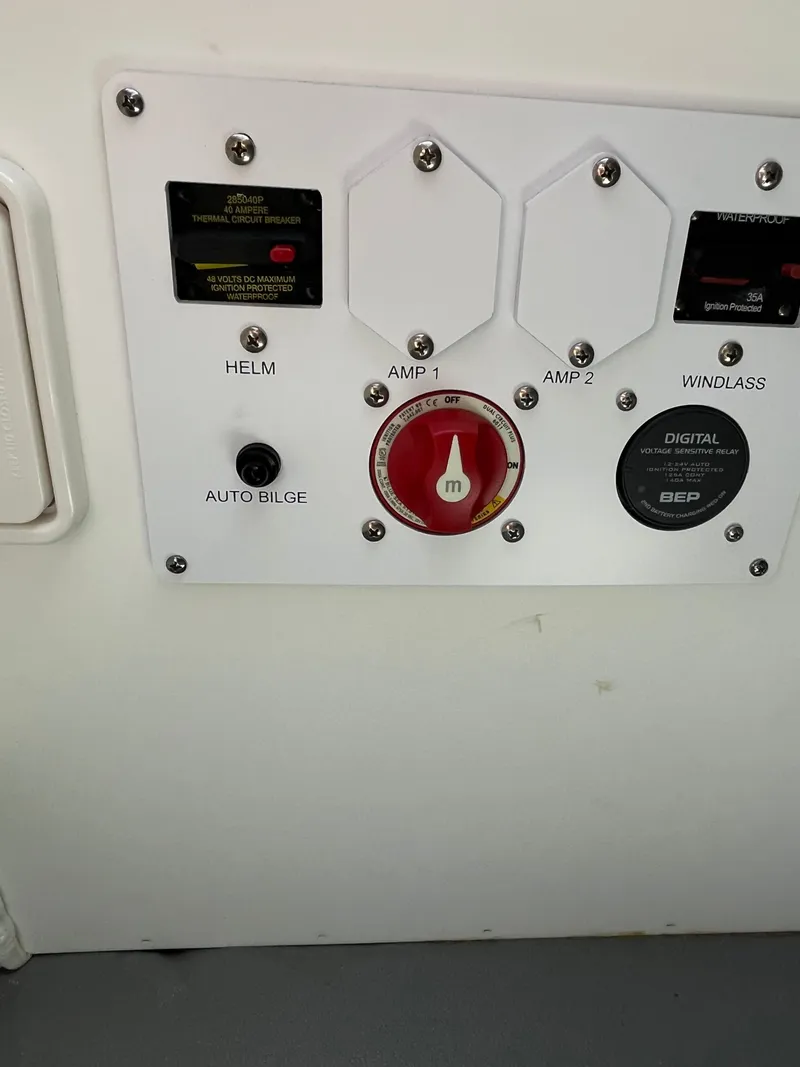 Slide: The Image of Control panel of 2024 Crownline 270 SS boat with various switches and indicators. - 19