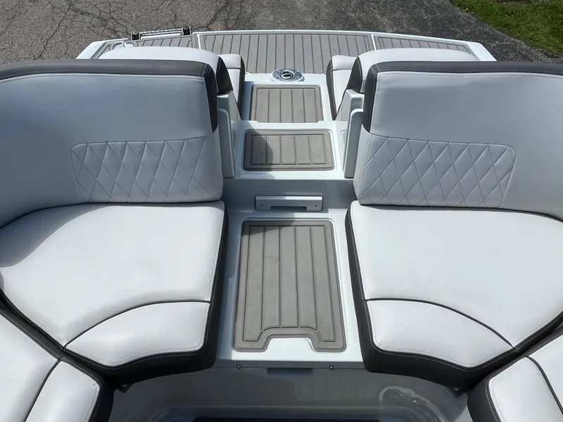 Slide: The Image of 2024 Crownline 270 SS boat interior with white cushioned seating and gray accents. - 6