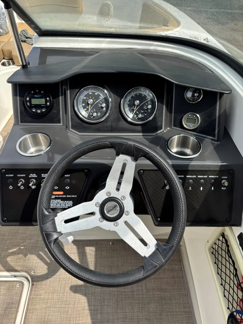 Slide: The Image of 2022 Bayliner VR6 Bowrider I/O dashboard with steering wheel and gauges. - 6